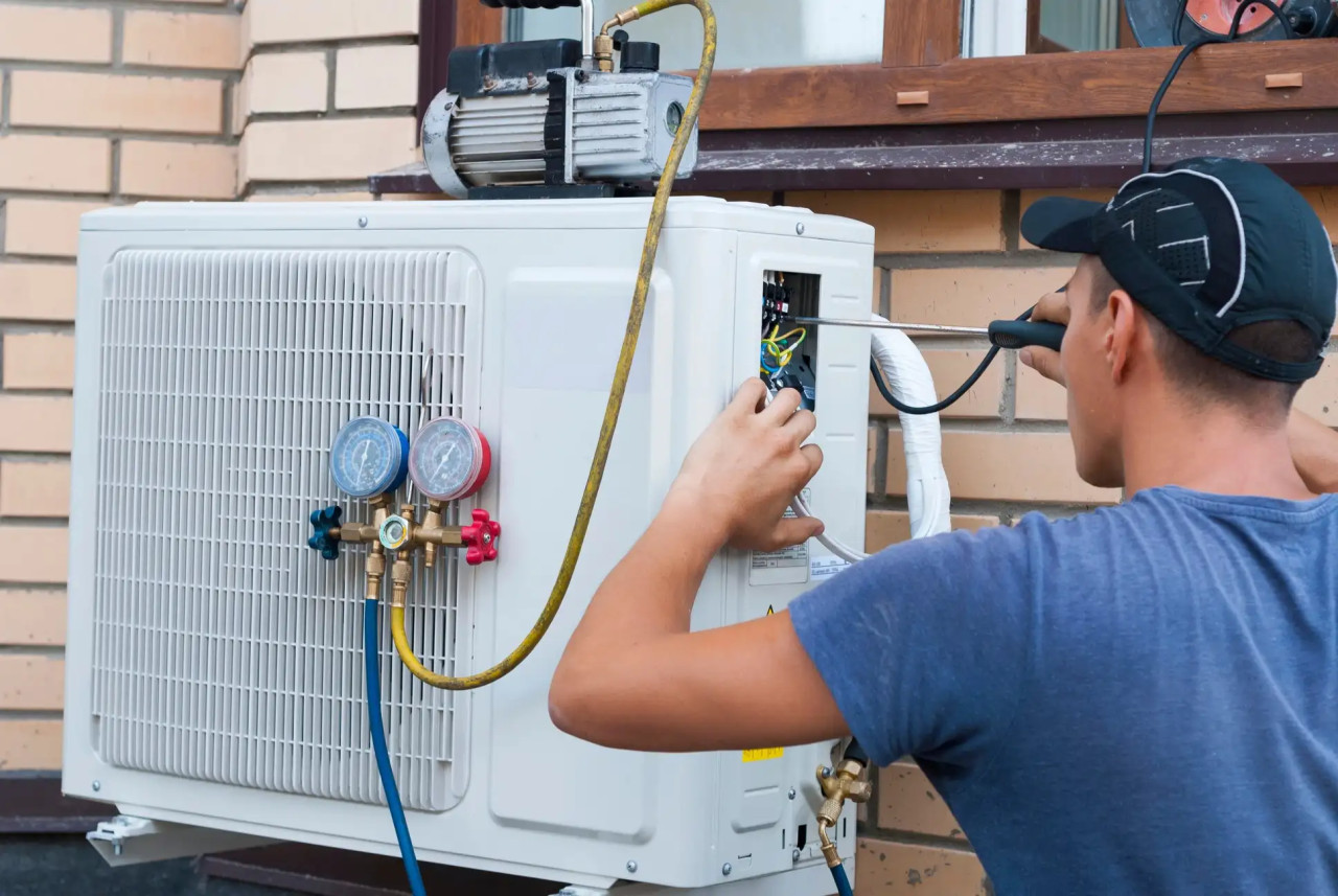 hvac-technician-inspecting-ac-unit