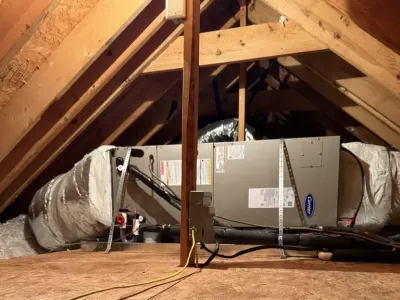 Carrier heating and cooling system installation in a residential attic space.