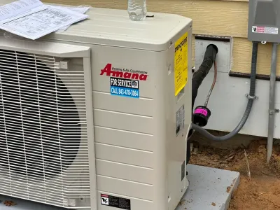 Outdoor Amana heat pump installation and HVAC service by Complete Refrigeration Services.