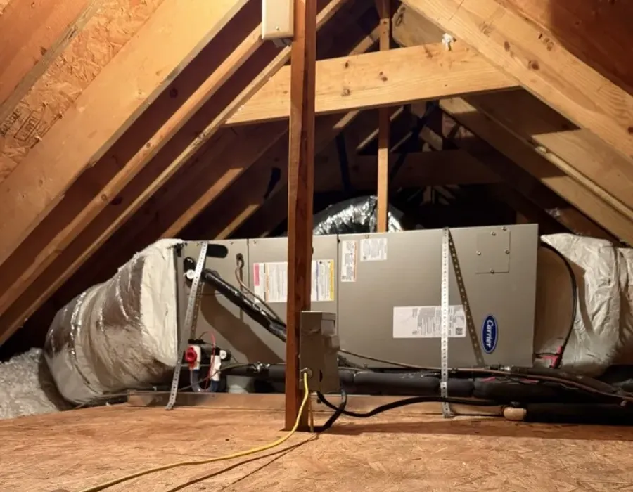 Carrier HVAC unit and ductwork installed in an attic by commercial cooling experts.
