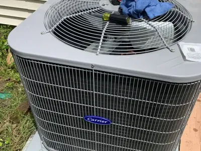 Carrier outdoor AC condenser unit installation for residential or commercial cooling.